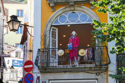 Rear view of woman standing against building