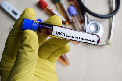 Cropped hand holding thermometer