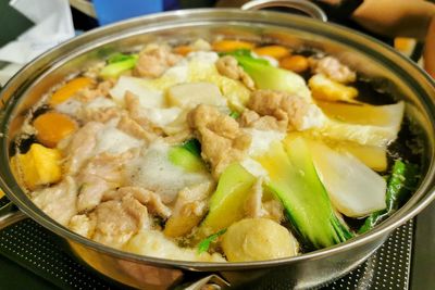 High angle view of vegetable and pork in hot pot