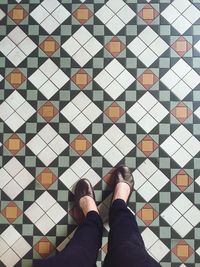 Low section of woman standing on patterned floor