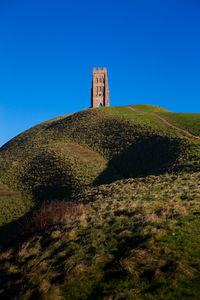 Low angle view of fort against clear blue sky