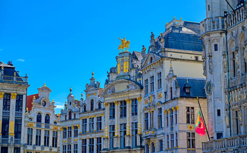 Low angle view of buildings against blue sky