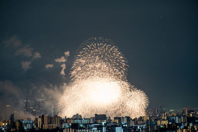 City illuminated by fireworks at night