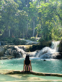 Woman in bikini at luang prabang turquoise kuang si waterfall