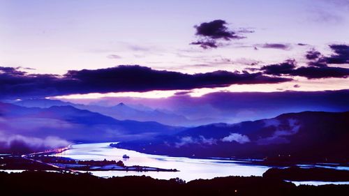 Scenic view of mountains against sky at sunset