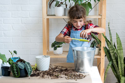 Portrait of cute girl picking food at home