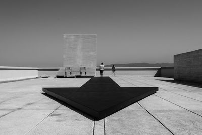 People at observation point against clear sky