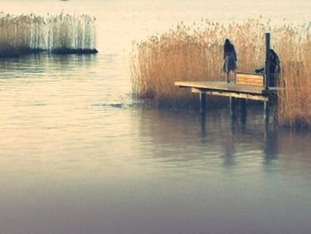 Woman sitting by lake