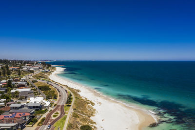 Scenic view of beach against blue sky