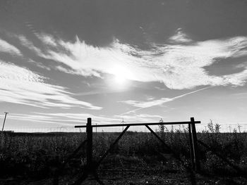 Fence on field against sky