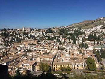 View of cityscape against blue sky