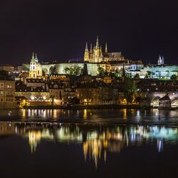 Illuminated buildings against sky at night