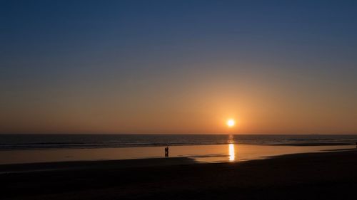 Scenic view of sea against clear sky during sunset