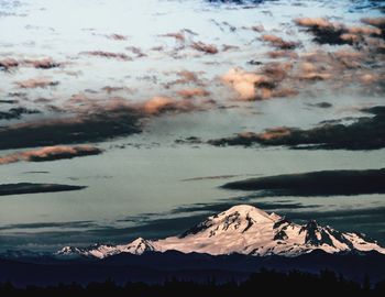 Scenic view of snowcapped mountains against sky during sunset