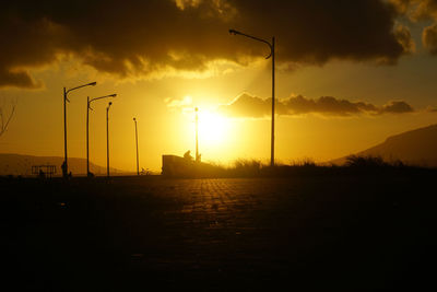 Scenic view of silhouette field against sky during sunset