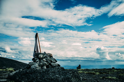 Statue on beach against sky