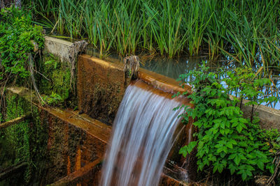High angle view of water flowing on dam