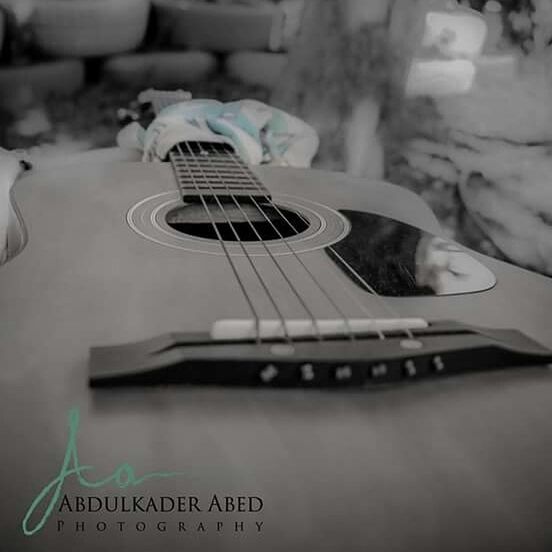 indoors, music, musical instrument, still life, close-up, arts culture and entertainment, musical equipment, selective focus, focus on foreground, guitar, communication, book, musical instrument string, table, technology, education, acoustic guitar, text, single object, paper