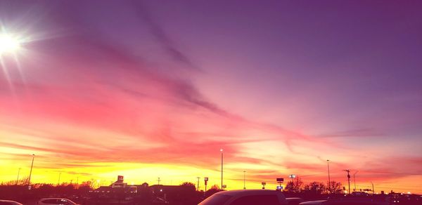 Silhouette buildings against sky during sunset