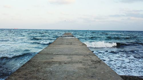 Pier on sea against sky