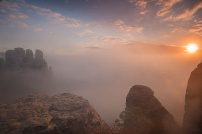 Scenic view of rock formation against sky during sunset