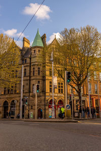 Street by building against sky in city
