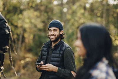 Young man using smart phone outdoors