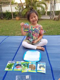 Portrait of smiling girl sitting outdoors