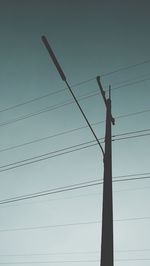 Low angle view of power lines against sky