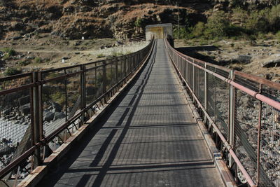 High angle view of footbridge leading towards mountain