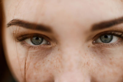 Close-up portrait of teenage girl with red head