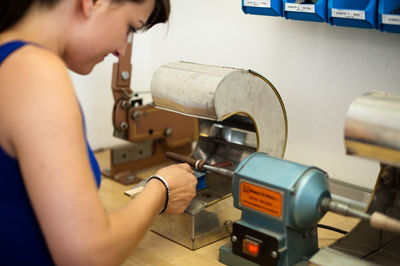 Woman making ring in workshop