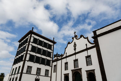 Low angle view of text on building against sky