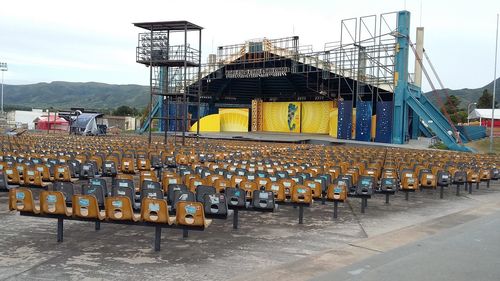 Group of people in stadium against sky