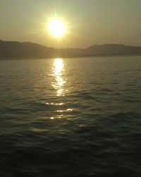 Scenic view of sea and mountains during sunset