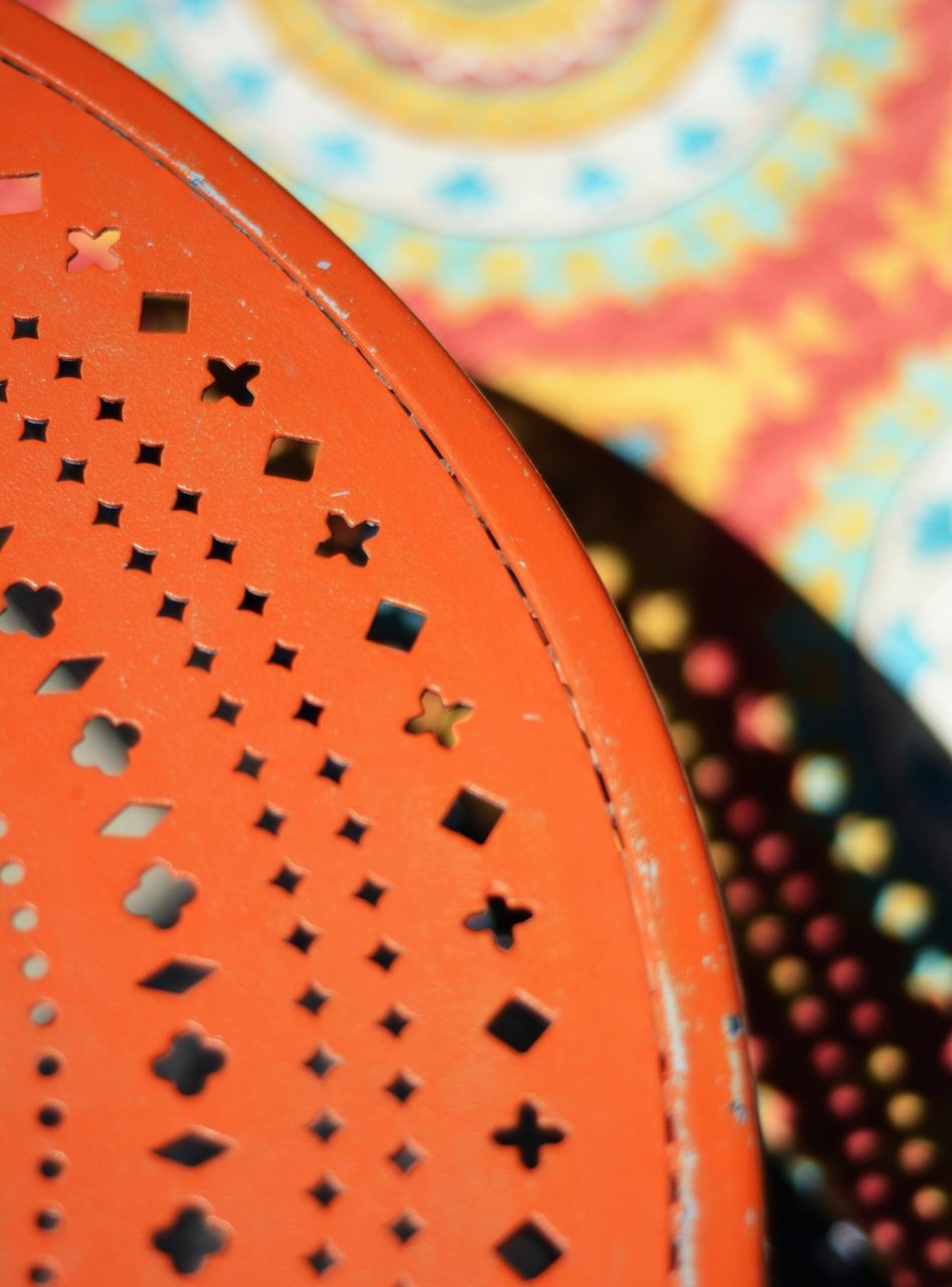 indoors, close-up, full frame, pattern, backgrounds, metal, metallic, circle, design, selective focus, red, orange color, still life, detail, repetition, no people, textured, focus on foreground, geometric shape, in a row