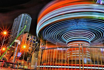 Low angle view of illuminated ferris wheel at night