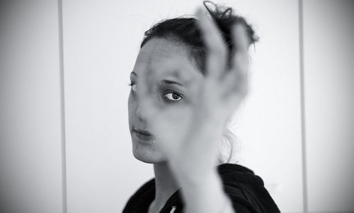 Portrait of women gesturing against wall