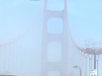 Low angle view of suspension bridge against sky