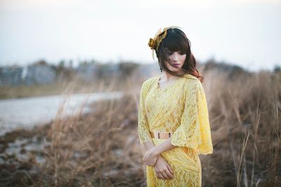Woman standing on field against sky