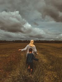 Woman on field against sky