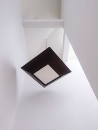 High angle view of paper on white wall