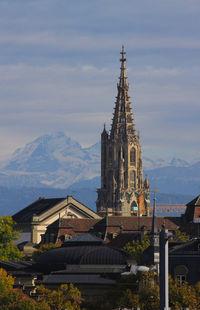View of church building against cloudy sky and mountain
