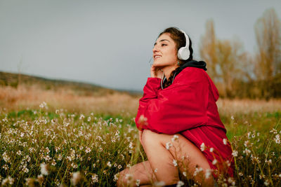 Side view of smiling woman on field