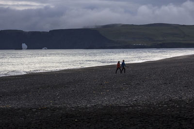 Man on beach against sky