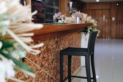 Brown wicker rattan chair at bar counter at cafe coffee shop