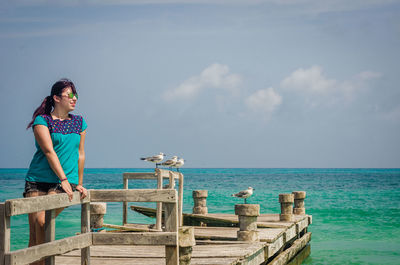Boy on sea against sky