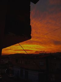 Low angle view of silhouette buildings against sky during sunset