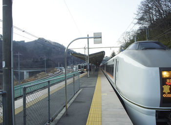 Train at railroad station against clear sky