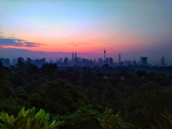 View of buildings in city during sunset